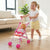 A young girl pushing a 12-Inch Baby Doll and Foldable Stroller with a doll inside, encouraging imaginative play.