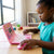 Child using the 65 Functions Intelligent Kids Laptop Learning Machine Toy for educational activities.