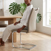 Cantilever Chrome Bar Stool with Backrest in a stylish setting with a woman seated beside a wooden table.