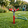 Garden Irrigation System with Adjustable 4-Arm Sprinkler in a lush green garden watering the lawn.