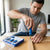 A person using a Professional Phillips Head Screwdriver with Steel Handle to assemble furniture.
