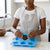 Person using the 6 Cavity Heart Silicone Soap Mold to create heart-shaped soaps in a modern kitchen.