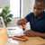 Person using the 37 Piece CRV Precision Ratchet Screwdriver Bit Set while working on a laptop at a wooden desk.
