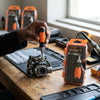 Person using the 37 Piece CRV Precision Ratchet Screwdriver Bit Set to work on a device in a workshop.