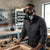 Man wearing an Anti-Pollution Industrial Gas Mask while working in a workshop with tools.