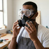 Man wearing an Anti-Pollution Industrial Gas Mask and goggles for respiratory protection.