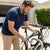 Man securing a bicycle with a 10mm Heavy Duty Anti-Theft Chain Lock for enhanced security.