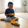 Child playing with a 1:30 Scale Remote Control Construction Crane Truck in a bright living room.