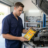 Man checking Automotive Bolt-On Fuse at a car engine, ensuring vehicle electrical safety and performance.