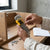 Person holding Carbon Steel L-Type Torx Hex Key Set while assembling furniture.