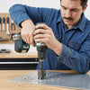 Man using EXTREME Impact Pivoting Bit Tip Holder with a drill on a metal sheet in a workshop.