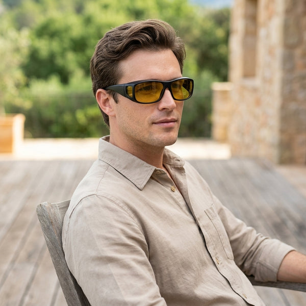 Man wearing HD Vision Wrap Around Night Driving Glasses outdoors, showcasing their sleek design and glare-reducing features.