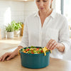 Woman preparing salad in the 2300ml Leakproof Airtight Plastic Food Container with yellow locking latches.