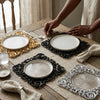 Luxury 12 Inch Eco-Friendly Disposable Round Plate: A wooden table set with luxury decorated disposable round plates in gold, black, and silver for elegant dining.
