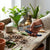 Person using 8 Inch Heavy Duty Bypass Garden Pruning Shears to trim a plant in a potting setup.