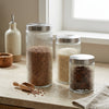 Ribbed Glass Airtight Food Storage Jar displayed with different contents including lentils, rice, and spices.