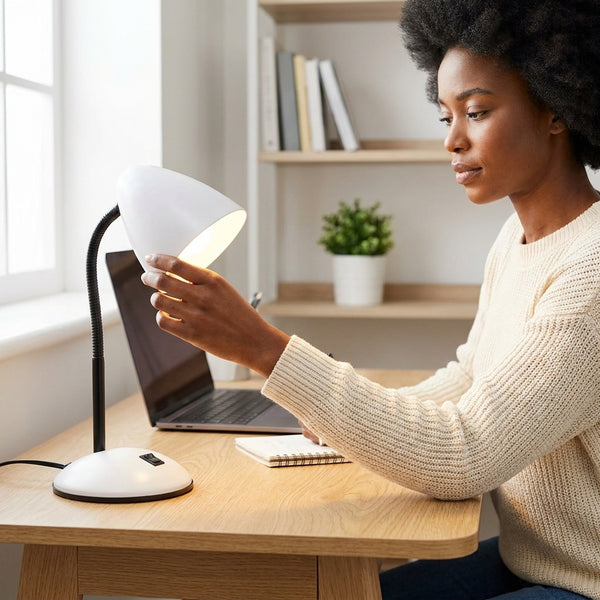 Person adjusting the Flexible Gooseneck Desktop Table Lamp on a wooden desk with a laptop and notebook.