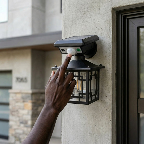 Outdoor Solar Lamp Waterproof Human Induction Light being activated by hand on exterior wall.