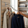 Wall Mounted Metal Multi-functional Waterfall Hook displaying various garments for easy access and organization.