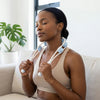 Woman using Handheld Back Pulling Muscle Massage Roller to relieve tension and relax muscles.