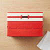 Foldable Plastic Storage Box with Lid in red on wooden surface beside a white cloth.