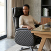 Executive Genuine Leather Reclining Office Chair in a modern workspace with a woman sitting comfortably at a desk.