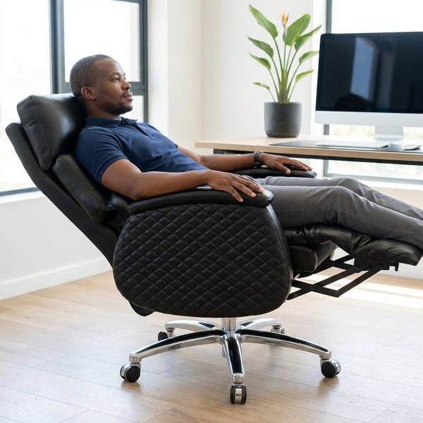Comfortable man reclining in an Executive Genuine Leather Reclining Office Chair at a modern workspace.