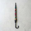 Colorful Patterned Long Handle Umbrella closed and ready for use, showcasing vibrant patterns on the canopy.