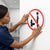 No Public Urination Warning Sign being installed on a bathroom door to promote cleanliness and proper behavior.