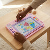 Kids Electronic LCD Writing and Drawing Tablet in use, featuring colorful designs and drawing tools on a wooden table.