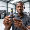 A person holding a 400W LED Headlight Bulbs, showcasing its design and features for automotive lighting.