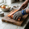 Level 9 Stainless Steel Mesh Cut Resistant Glove protecting hands while cutting salmon on a wooden board.