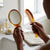 Classic Mirror and Comb Grooming Set featuring a tortoiseshell handheld mirror and comb on a bathroom counter.