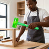 Man using an Industrial Copper Soft Face Machinist Hammer on wooden furniture in a workshop.