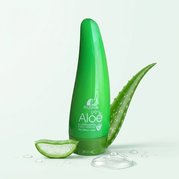 Aloe Vera Soothing Moisture Conditioner bottle with aloe vera leaf and slice, promoting hydration and softness for hair.