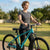 Full Suspension Enduro Mountain Bike with 160mm Travel, woman standing with bike in a park.