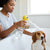 Person using the ABS Pet Bubble Machine for Cats and Dogs to bathe a dog in a bathtub.