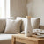 3 in 1 Warm Towel Steamer and Humidifier on a wooden table in a cozy living space with soft cushions.
