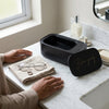 Professional Ultrasonic Mini Jewelry Cleaner on a countertop next to glasses and a ring.