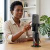 Woman using the 360 Degree Intelligent Face Tracking Camera for hands-free video recording.