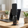 360 Degree Intelligent Face Tracking Camera mounted on desk with a smartphone, designed for hands-free video recording.