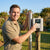 2HP Solar Deep Well Borehole Pump installation with user demonstrating control panel outdoors.