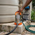 Brushless Solar Water Pump placed next to a water tank, used for efficient water transfer with solar energy.