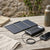 Multifunction Powerbank Folding Solar Panel 5W on wooden table with smartphone charging.