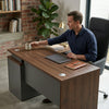 1.4 Modern Durable Eco-Friendly L-Shaped Office Desk with a man working and holding a mug.