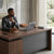L-Shape Executive Office Desk with Side Cabinet featuring a professional man using a laptop in a modern office setting.