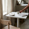 Modern Marble-Style Side Table with a mug and a newspaper in a contemporary kitchen.