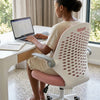 A person using a laptop while sitting in a Liftable Swivel Study and Office Chair with Breathable Back at a desk.