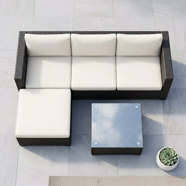 4 Piece Modular PE Rattan Outdoor Sectional Sofa with Coffee Table in an outdoor setting on a patio.