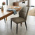 Modern Faux Leather Dining Chair with Channel-Tufted Back in a stylish dining room setting.